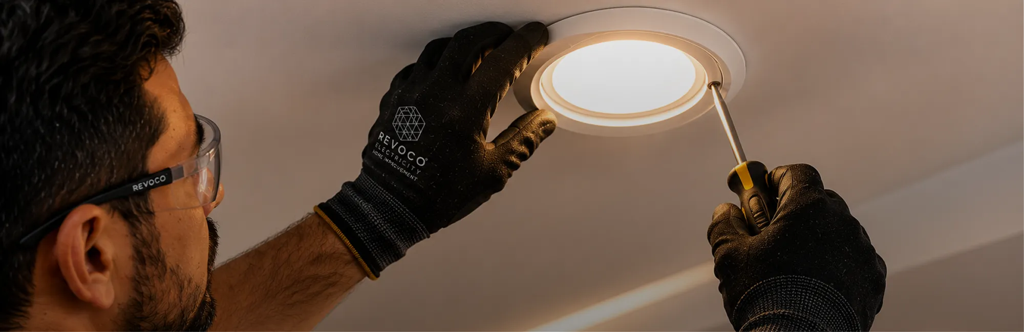 Electrician repairing a ceiling light